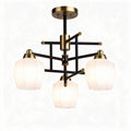 Three-light modern ceiling chandelier in black and brass with glass shades